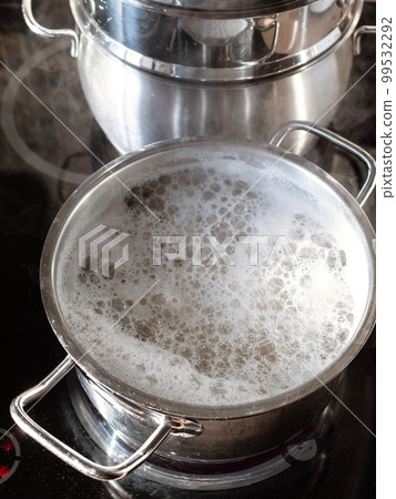pasta cooking in boiling water in saucepan at home 99532292