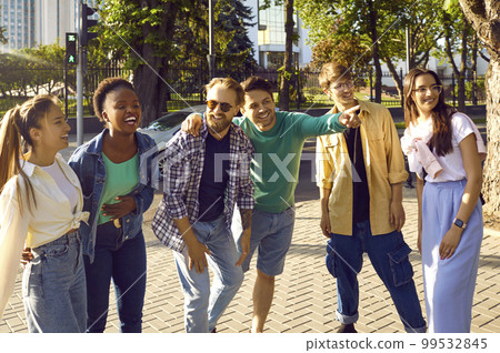 Group of cheerful tourist friends are walking together on streets of new city and exploring. Group of cheerful tourist friends are walking together on streets of new city and exploring. 99532845