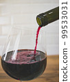 Pouring red wine into glass. Selective focus. 99533031