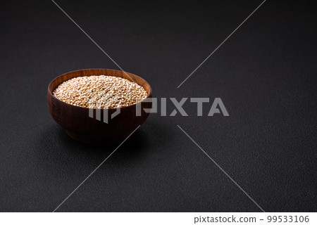 Wholesome raw quinoa in a bowl on a dark concrete background 99533106