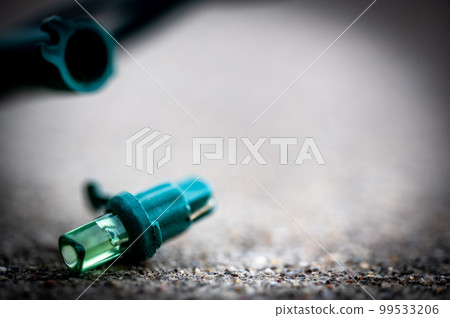 Focus on replacement bulb for a string of Christmas lights to repair a dud. Focus on replacement bulb for a string of Christmas lights to repair a dud. 99533206