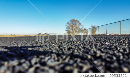 Ground level photo of a rubberized track surface. Ground level photo of a rubberized track surface. 99533221