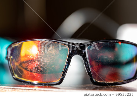 macro of the scratched surface of a polarized sunglasses lens 99533225