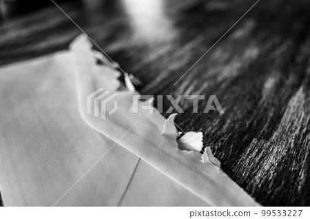 Selective focus on jagged edges of a ripped open mail envelope Selective focus on jagged edges of a ripped open mail envelope 99533227