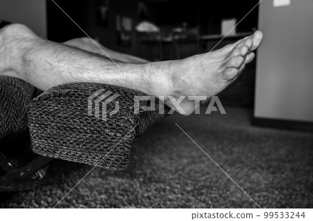 white Caucasian male with feet elevated on reclining chair 99533244