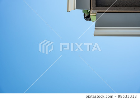 Metal gutters be installed on a residential buildings with two sections coming together for a 90 degree connection.  99533318