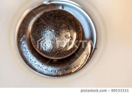 Selective focus on an open bronze sink drain. 99533331