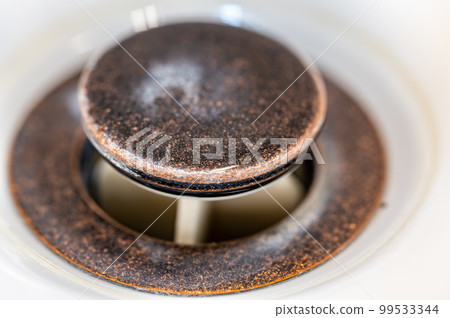 Selective focus on an open bronze sink drain. Selective focus on an open bronze sink drain. 99533344