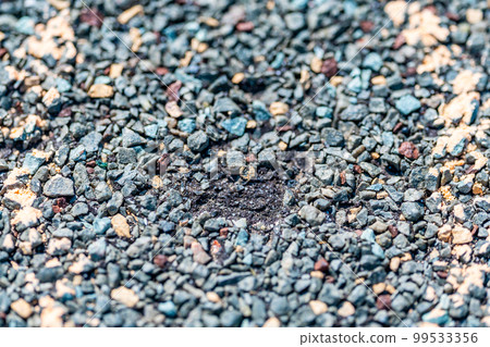 Macro of hail damage on a shingle residential roof circled with a chalk outline during a home inspection. 99533356