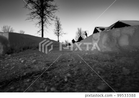 Selective focus ground level view of snow blown sidewalk section with path continuing.  99533388