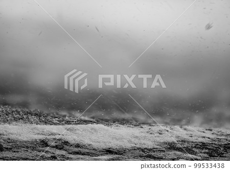 Blowing snow and Focus stacked ground level view of ice accumulation on a sidewalk with blowing snow. Blowing snow and Focus stacked ground level view of ice accumulation on a sidewalk with blowing snow. 99533438