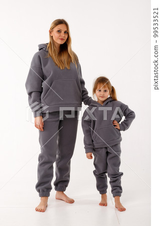 Sporty mom and her little daughter in thermal clothes. Sporty mom and her little daughter in thermal clothes. 99533521