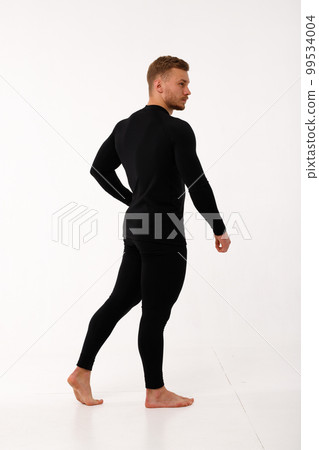 A man with a sporty physique in thermal underwear. A man with a sporty physique in thermal underwear. 99534004