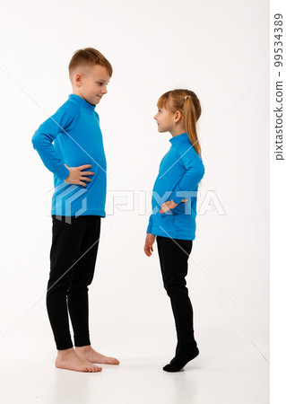 A little girl and her older brother in thermal clothes. A little girl and her older brother in thermal clothes. 99534389