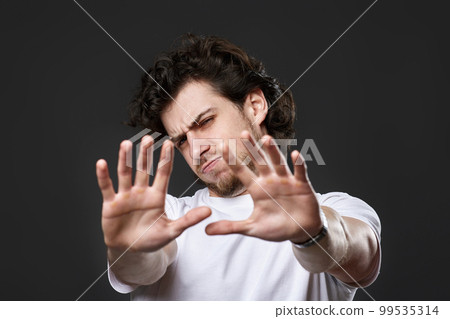 young upset bearded man showing stop gesture 99535314