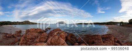 Rocky and Sandy Beach in Porto Istana, Sardinia, Italy. Tavolara Island in Background. 99536048
