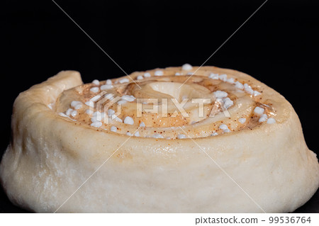 Uncooked homemade cinnamon bun in electric oven Uncooked homemade cinnamon bun in electric oven 99536764