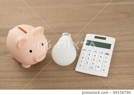 Power saving image LED light bulb, calculator and piggy bank Power saving image LED light bulb, calculator and piggy bank 99536790