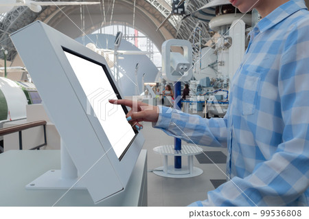 Woman hand touching interactive white touchscreen display kiosk: close up Woman hand touching interactive white touchscreen display kiosk: close up 99536808