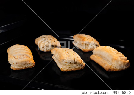 Five buns with ham, cheese baking in electric oven Five buns with ham, cheese baking in electric oven 99536860