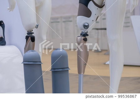 Dummy with modern prosthetic leg at medical exhibition 99536867