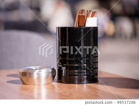 Empty tables outside between lunch hours along a cobblestone alley in a European city, a veranda, a cafe Empty tables outside between lunch hours along a cobblestone alley in a European city, a veranda, a cafe 99537286