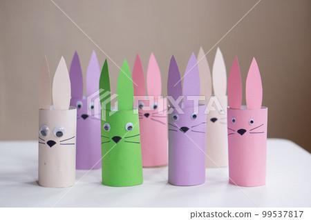 A banner from handmade easter bunny toy gift on a white table background. Paper easter rabbits. Happy easter. A banner from handmade easter bunny toy gift on a white table background. Paper easter rabbits. Happy easter. 99537817