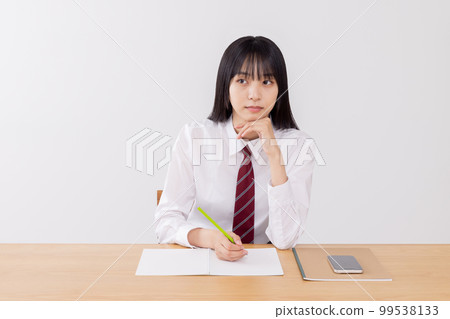 High school girl listening seriously to class 99538133
