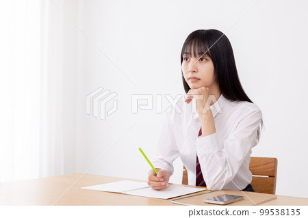 High school girl listening seriously to class High school girl listening seriously to class 99538135