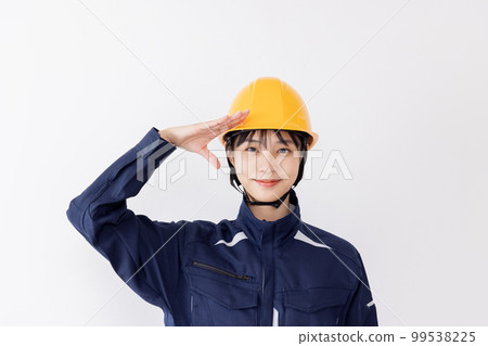 A woman in work clothes saluting A woman in work clothes saluting 99538225