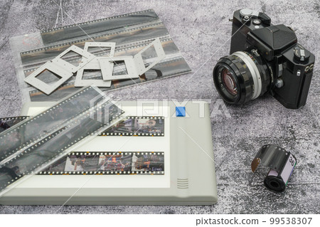 Old SLR camera and reversal film Old SLR camera and reversal film 99538307