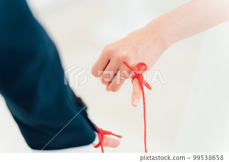 A bride and groom tied with a red thread at a wedding hall (bridal wedding) A bride and groom tied with a red thread at a wedding hall (bridal wedding) 99538658