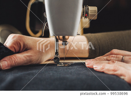 Woman working with sewing machine 99538696