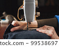 Woman working with sewing machine 99538697