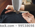 Woman working with sewing machine 99538698