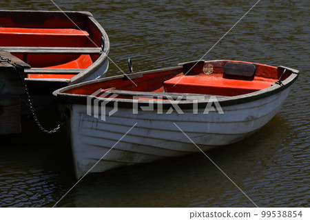 Rowing Boats Tied To Wooden Lake Pier Rowing Boats Tied To Wooden Lake Pier 99538854