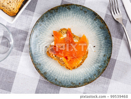 canapes with delicate butter and pieces of bright pink salmon 99539468