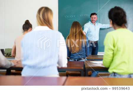 Young teacher is giving a lecture to students 99539643