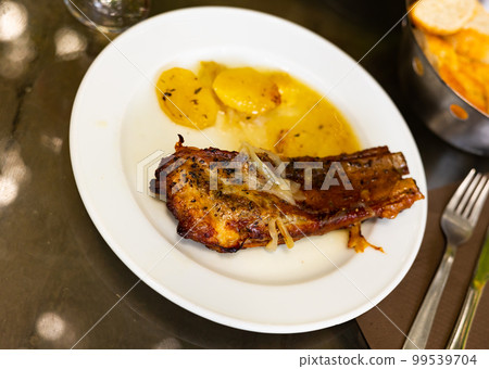 juicy and fatty fried pork ribs with crust, seasoned with coarse sal 99539704