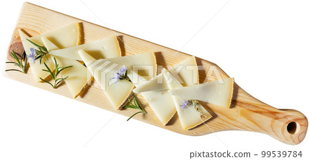 Slices of artisanal goat cheese with blooming rosemary for tasting Slices of artisanal goat cheese with blooming rosemary for tasting 99539784