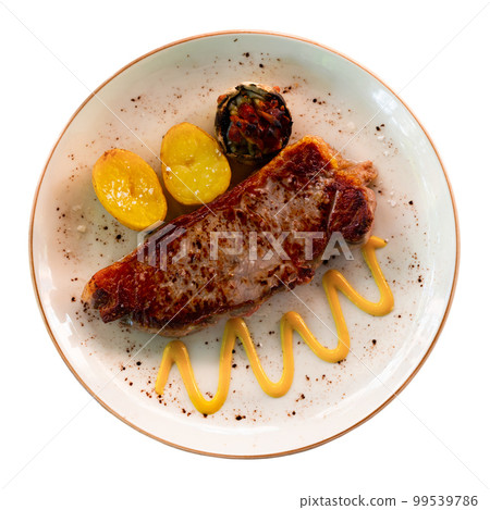 Beef entrecote served on plate with potatoes and mustard Beef entrecote served on plate with potatoes and mustard 99539786