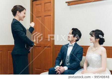 Concierge, hotel man, hotelier, wedding planner men and women in suits working at wedding halls and hotels 99540648