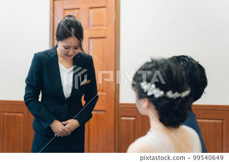 Concierge, hotel man, hotelier, wedding planner men and women in suits working at wedding halls and hotels 99540649
