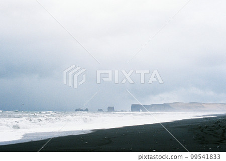 Black sand of Reynisfjara beach on the seashore. Iceland Black sand of Reynisfjara beach on the seashore. Iceland 99541833
