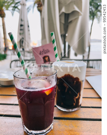 Cocktails with straws stand on a table in a restaurant 99542453