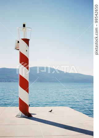 Solar powered automatic lighthouse at the pier in Porto. Montenegro Solar powered automatic lighthouse at the pier in Porto. Montenegro 99542650