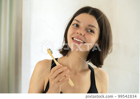 Young girl is cleaning her teeth. 99542834