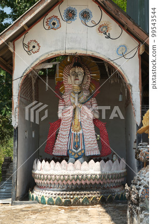 Traditional god or goddess made of wood at Wat Somdet, a historic site in  Amphoe Sangkhlaburi, Kanchanaburi Province , Middle of Thailand. A combination of Thai-Raman and Myanmar art.  Traditional god or goddess made of wood at Wat Somdet, a historic site in  Amphoe Sangkhlaburi, Kanchanaburi Province , Middle of Thailand. A combination of Thai-Raman and Myanmar art.  99543544