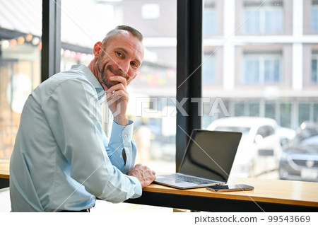 Happy Caucasian businessman or male office worker remote working at the coffee shop 99543669