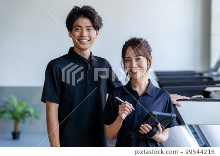 gym instructor with tablet 99544216